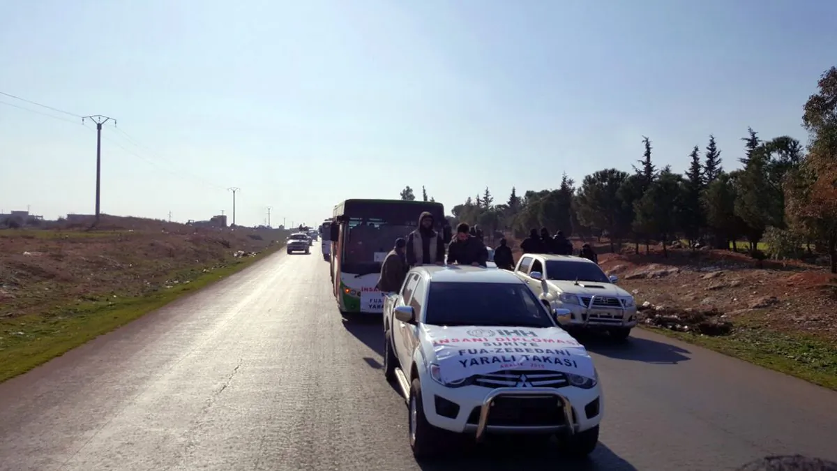 A convoy carrying 338 people evacuated from two Shiite villages in northern Syria heads towards Bab al-Hawa border crossing point with Turkey, in Syria, on Dec. 28, 2015. (IHH via AP)