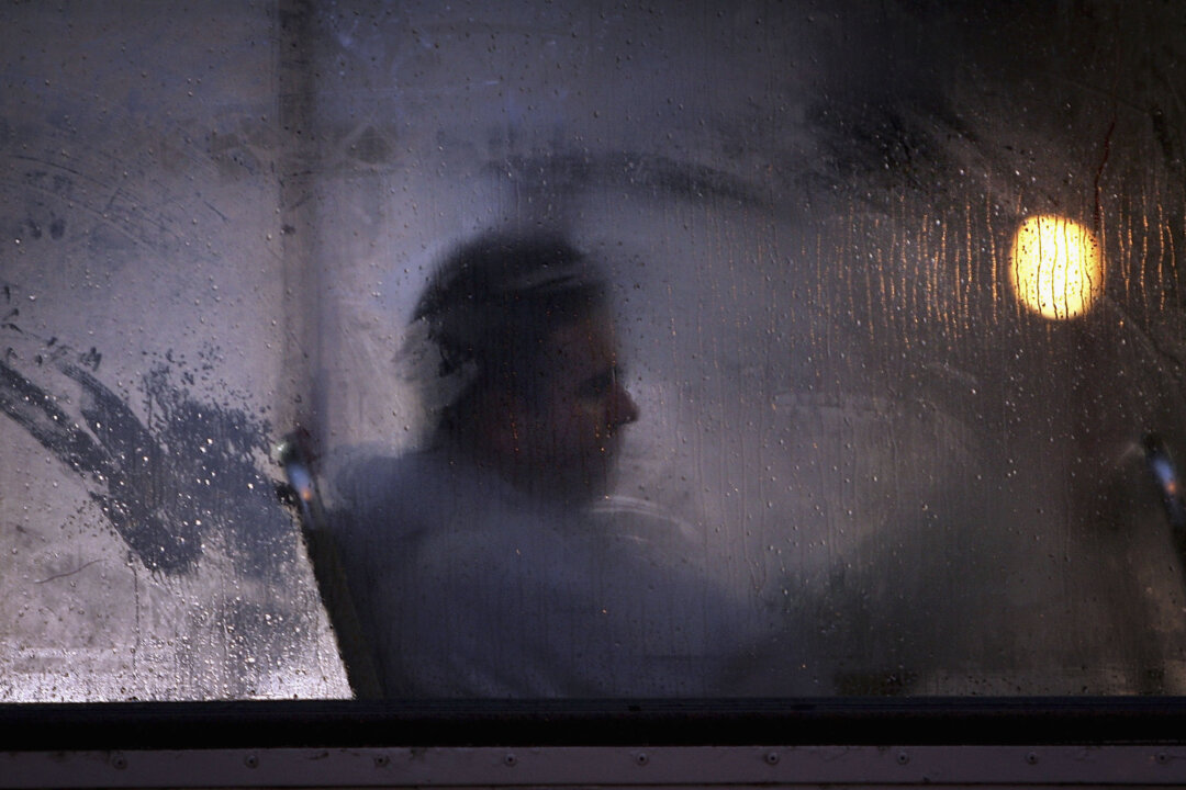 A man makes his way home from work on a bus as darkness falls in Glasgow, Scotland, on Oct. 10, 2005. Seasonal affective disorder (SAD), or winter depression, is a mood disorder related to the change in the seasons and the resulting reduction of exposure to daylight. (Christopher Furlong/Getty Images)