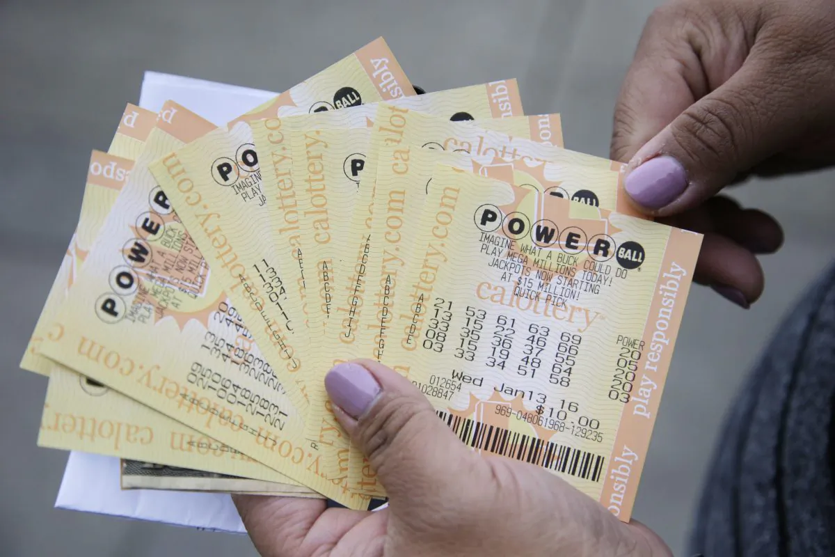 A person shows Powerball tickets she bought in San Lorenzo, Calif., on Jan. 12, 2016. (Marcio Jose Sanchez/AP Photo)