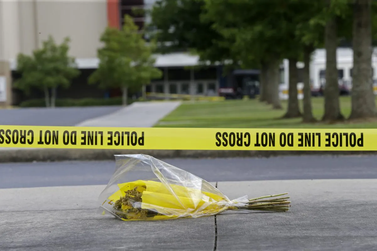 A bouquet of flowers lies next to a crime scene tape in a file photo. (Gerald Herbert/AP Photo)