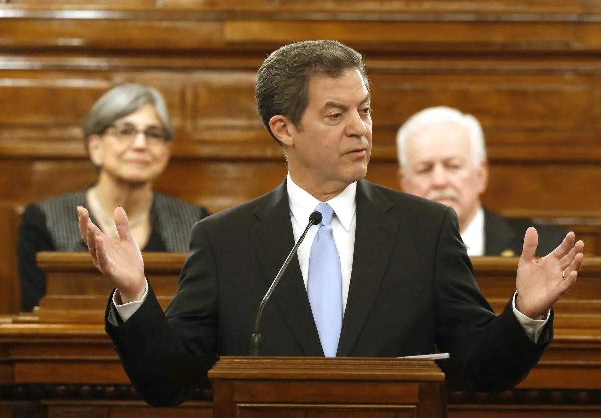 Kansas Gov. Sam Brownback addresses a joint session of the Kansas House and Senate during the annual State of the State speech in Topeka, Kan., Tuesday, Jan. 12, 2016. (Bo Rader/The Wichita Eagle via AP) 