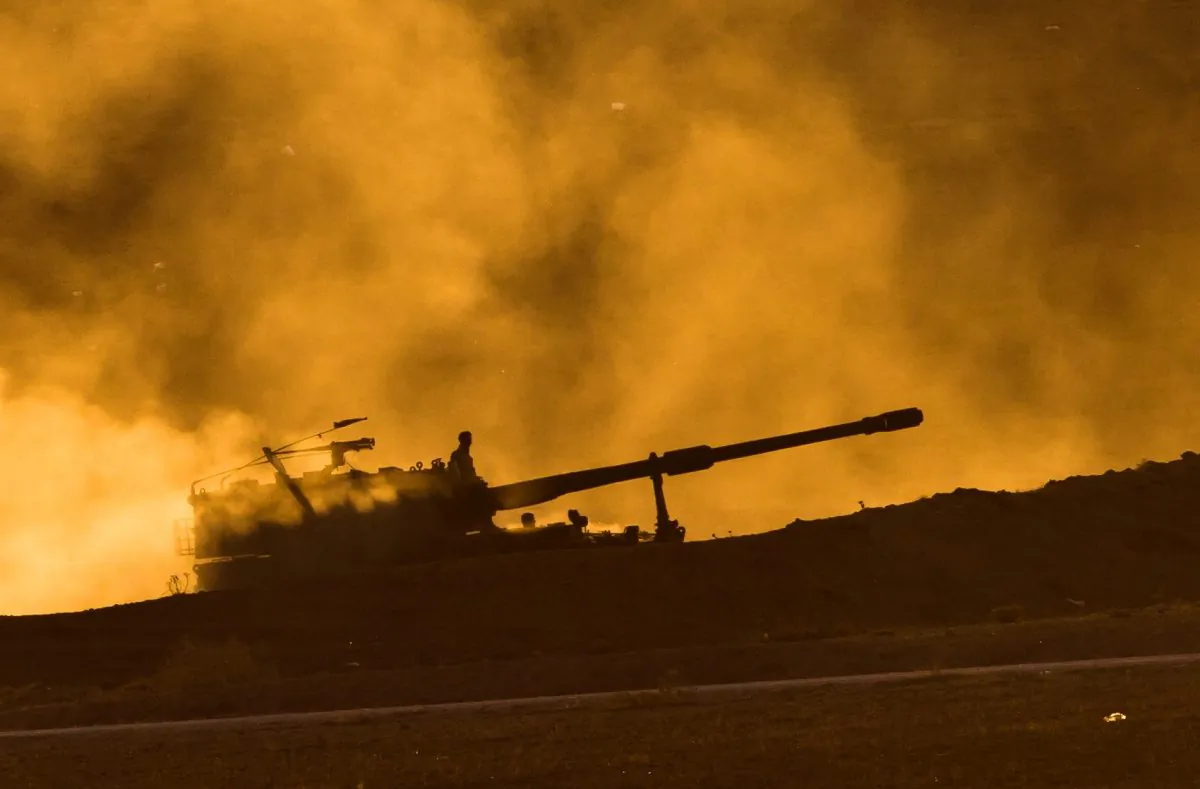 Turkish military mobile artillery unit driving at sunset on a hill overlooking the Syrian city of Kobani, outside Suruc, on the Turkey-Syria border, on Nov. 11, 2014. (AP Photo/Vadim Ghirda)