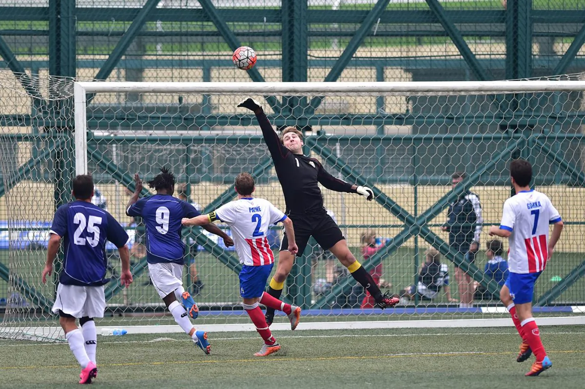 Squadron’s goalie covers this goal attempt by Albion during Albion's 3-nil victory in the Yau Yee League, first division match at Sports Road on Sunday Jan 10, 2016. (Bill Cox/Epoch Times)