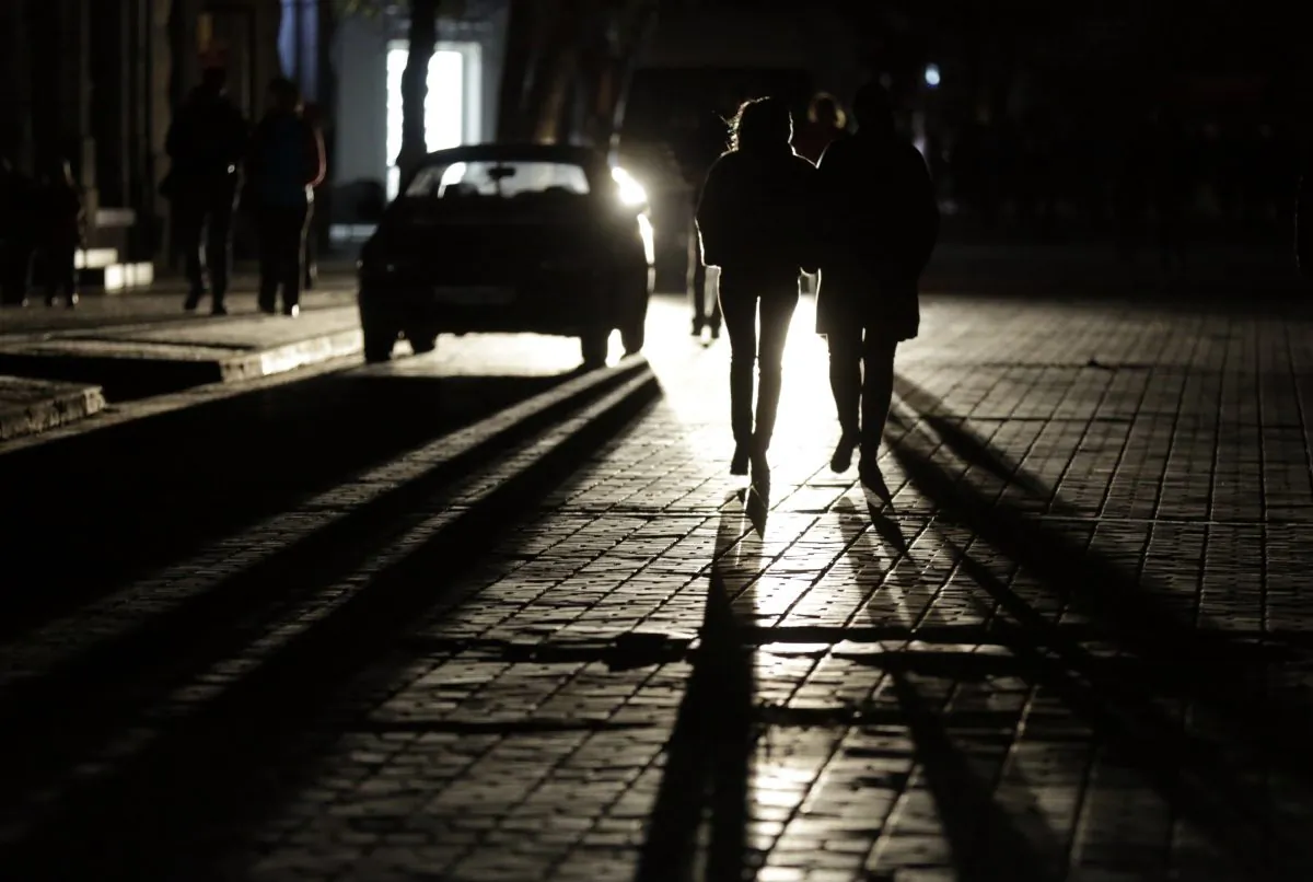 People walk along a street in the dark (Max Vetrov/AFP/Getty Images)