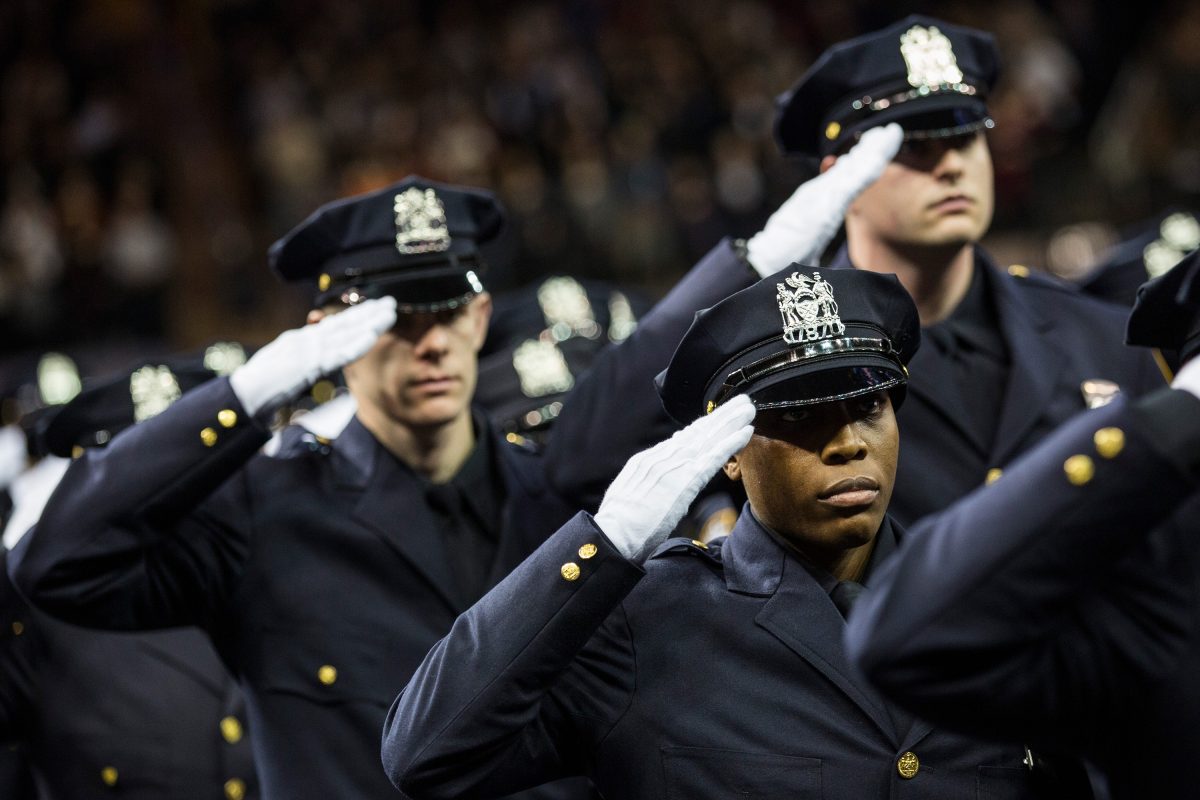 New police recruits salute during the NYPD graduation ceremony at Madison Square Garden in New York City on Dec. 29, 2015. More than 1,000 new graduates joined the police force. (Andrew Burton/Getty Images)