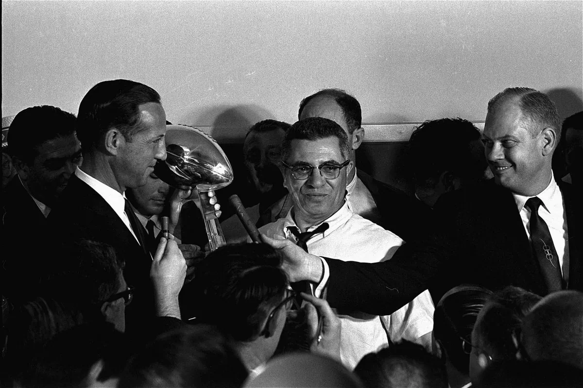 Football commissioner Pete Rozelle, left, presents the trophy to Coach Vince Lombardi of the Green Bay Packers in Los Angeles January 15, 1967, after the Packers trounced the Kansas City Chiefs 35 to 21 in the first Super Bowl football game. (AP Photo)