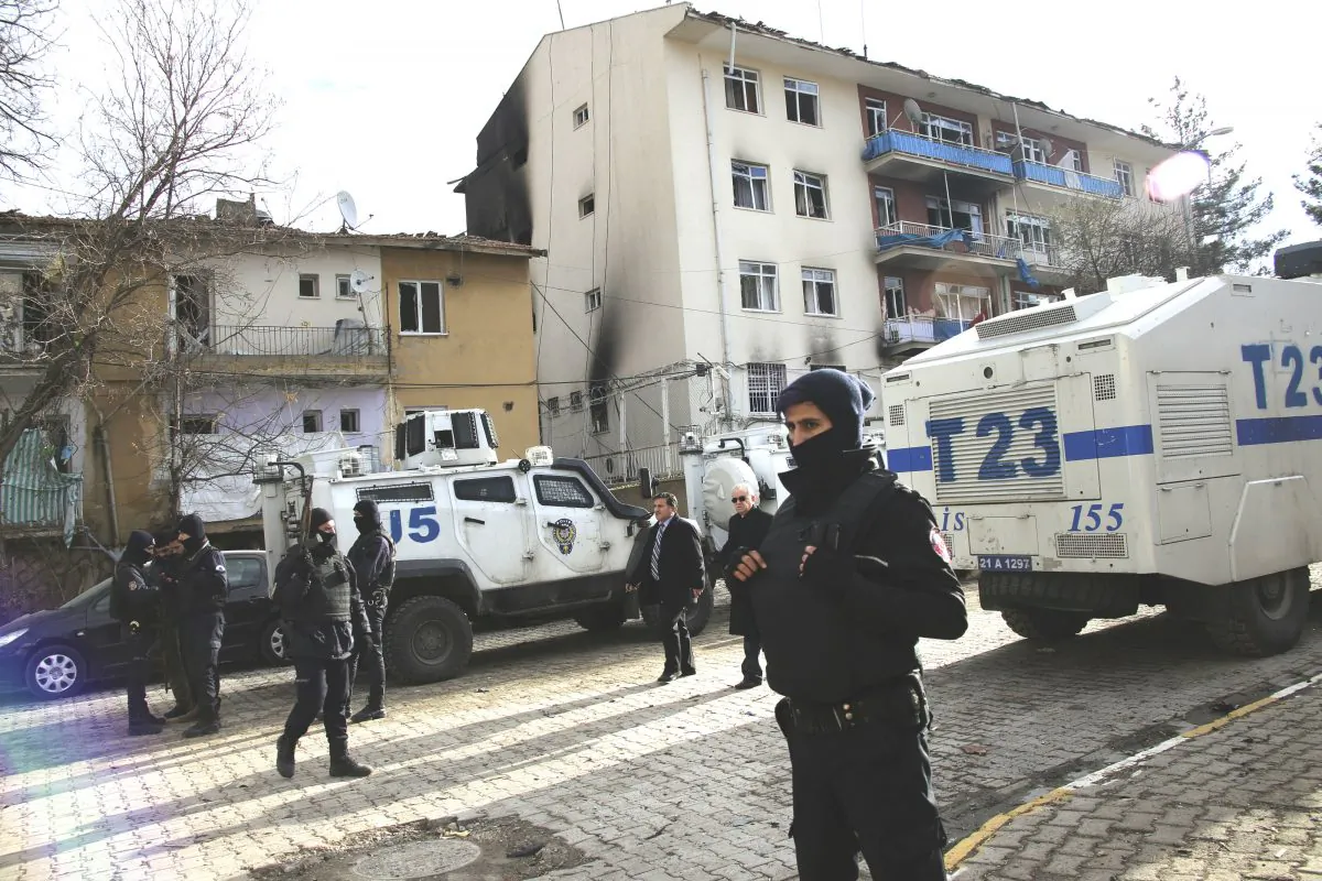 Turkish police officers secure the area around a destroyed police station compound in Cinar, in the mostly-Kurdish Diyarbakir province in southeastern Turkey, Thursday Jan. 14, 2016. (AP Photo/Mahmut Bozarslan)
