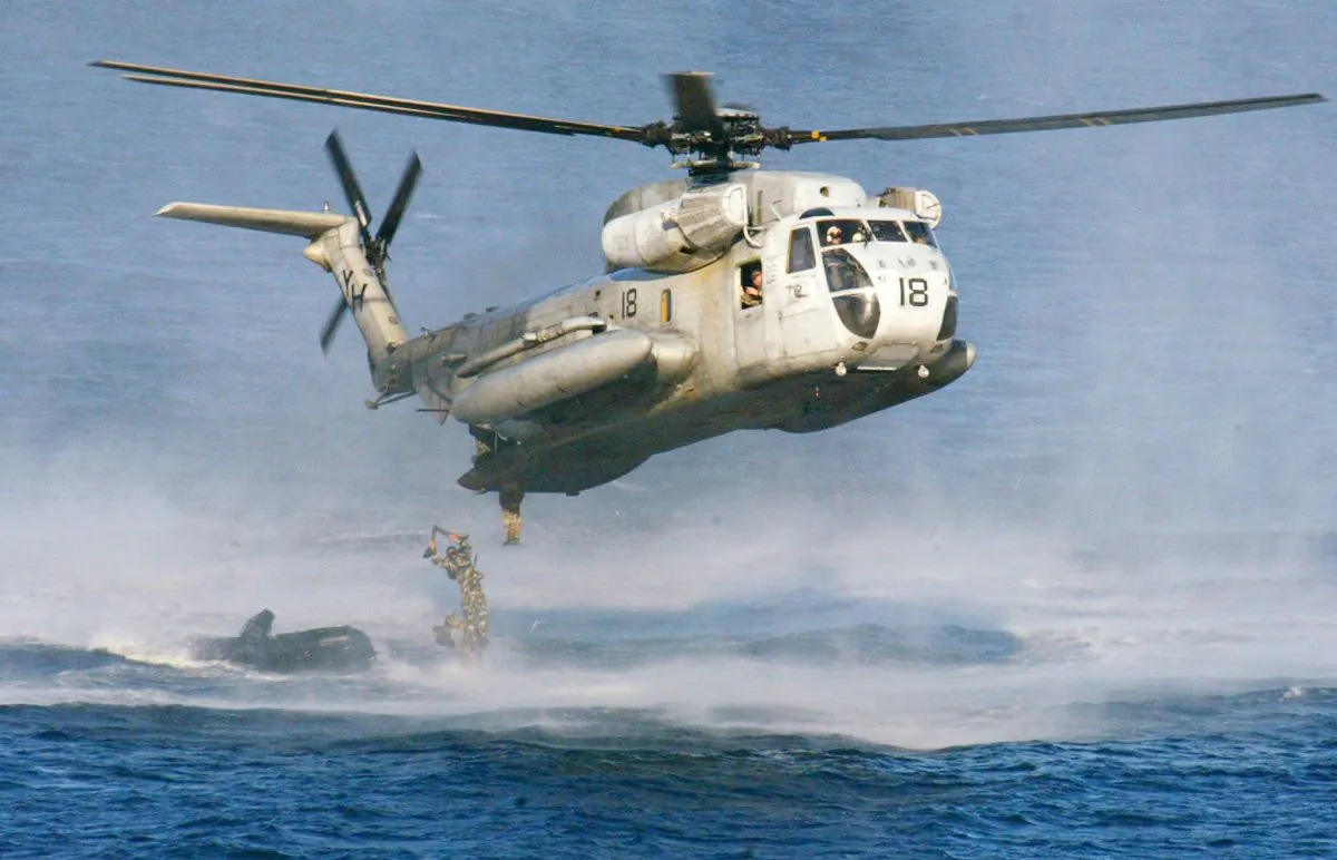 U.S. Marines and their Philippine counterparts jump from a U.S. Marines CH-53D Sea Stallion helicopter at Ternate in Cavite province south of Manila on Feb. 18, 2003. The U.S. Coast Guard says two similar Marine helicopters have collided off the Hawaiian island of Oahu on Jan. 15, 2016. (AP Photo/Bullit Marquez)