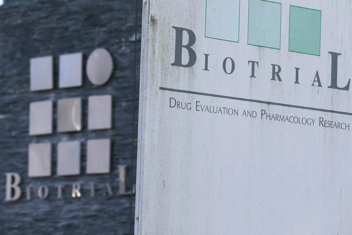 A logo of the Biotrial laboratory is displayed on its building in Rennes, western France, Friday, Jan. 15, 2016.  Officials say six volunteers have fallen ill after participating in a clinical trial in the French city of Rennes and one of them is brain-dead. The French Health Ministry said on Friday that the six were hospitalized after taking a medication that was in the first phase of testing to study safe usage, tolerance and other measures on healthy volunteers. (AP Photo/David Vincent)