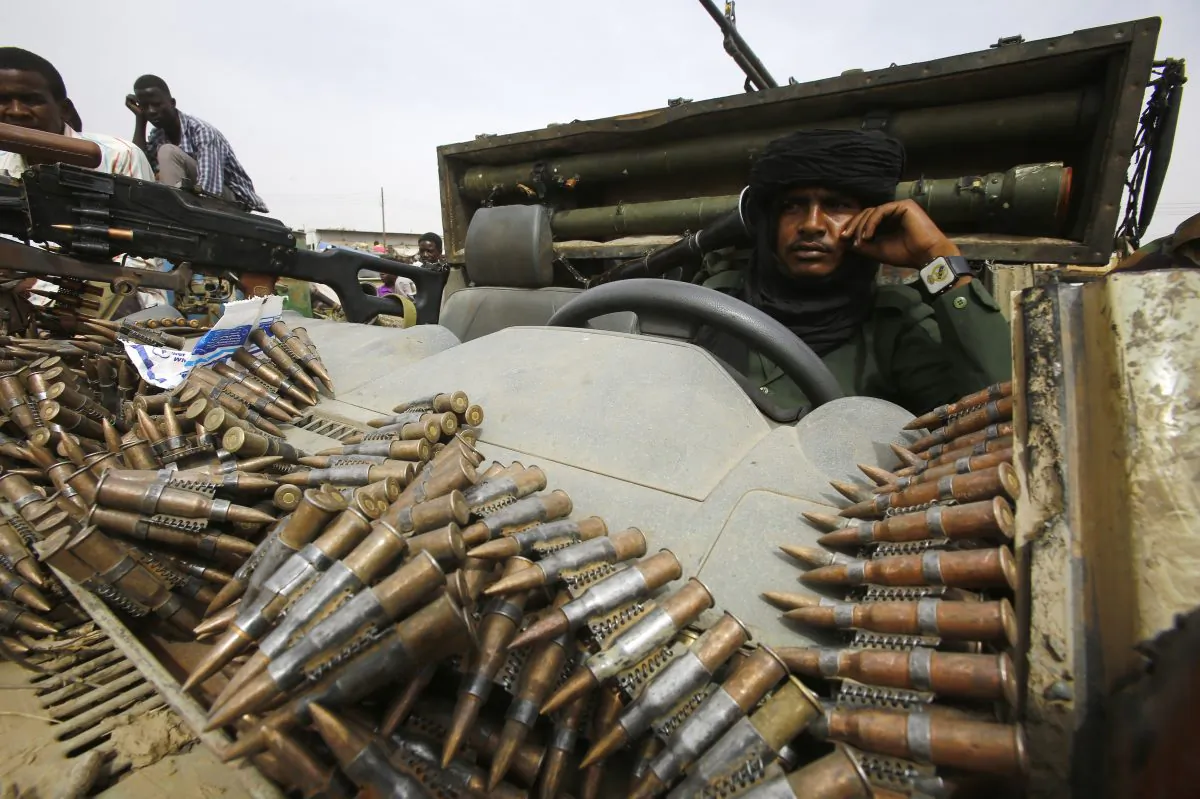 A fighter from the Sudanese Rapid Support Forces sits in an armed vehicle in the city of Nyala, in south Darfur, on May 3, 2015. (Ashraf Shazly/AFP/Getty Images)