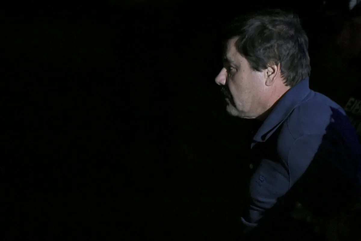 Drug kingpin Joaquin "El Chapo" Guzman is escorted to a helicopter at Mexico City's airport on Jan. 8, 2016, following his recapture during an intense military operation in Los Mochis, in Sinaloa State, Mexico. (Alfredo Estrella/AFP/Getty Images)