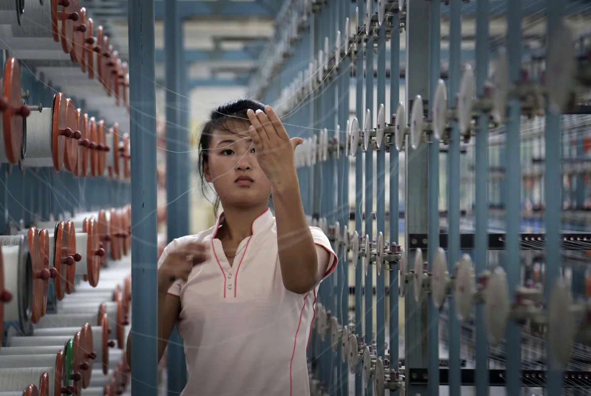 A North Korean woman works at the Kim Jong Suk Pyongyang textile factory, in Pyongyang, North Korea, on July 31, 2014. After ringing in the new year with claims of its first successful hydrogen bomb test, North Korea is now calling on the United States and the world community to accept it as a nuclear power, jettison the pursuit of punitive sanctions and allow it to focus on what it really wants: build up the nation’s troubled economy. (AP Photo/Wong Maye-E)