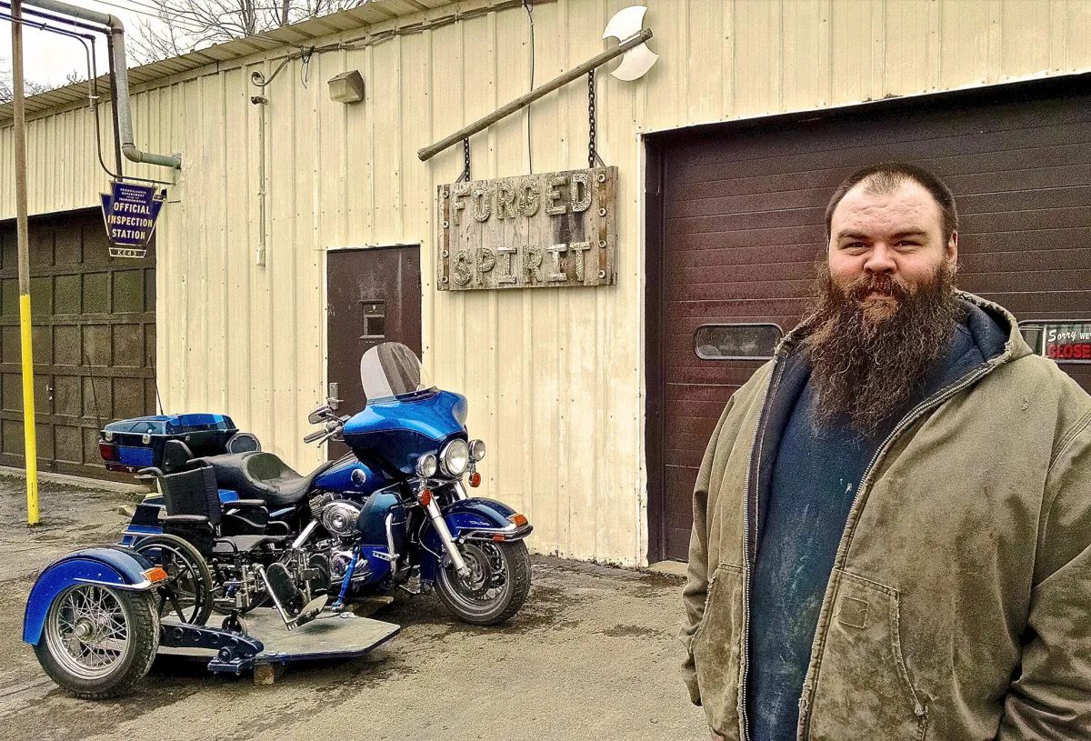 Brian Mahaney of Forged Spirit Garage shows off a wheelchair accessible sidecar in Bradford, Pa., on Dec. 30, 2015. Mahaney and his wife, Michelle, started "Forged Spirit Garage" this past summer with the intent to develop a wheelchair accessible sidecar, which offers what he calls "two-wheel therapy." (Josh Hatcher/The Bradford Era via AP)