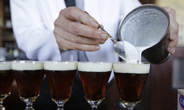 In this photo taken Tuesday, Dec. 15, 2015, bartender Paul Nolan makes Irish Coffee drinks at the Buena Vista Cafe in San Francisco. The drink has been made at the popular bar since 1952 and up to 2,000 are served a day. (AP Photo/Eric Risberg)