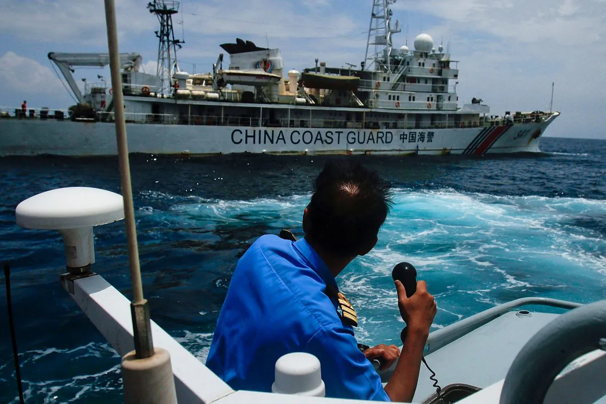 Chinese "little blue men" maritime militia in the South China Sea. A member of the Malaysian Navy in a communication exchange with a Chinese Coast Guard ship in the South China Sea, near Kuantan, Malaysia, on March 15, 2014. (Rahman Roslan/Getty Images)