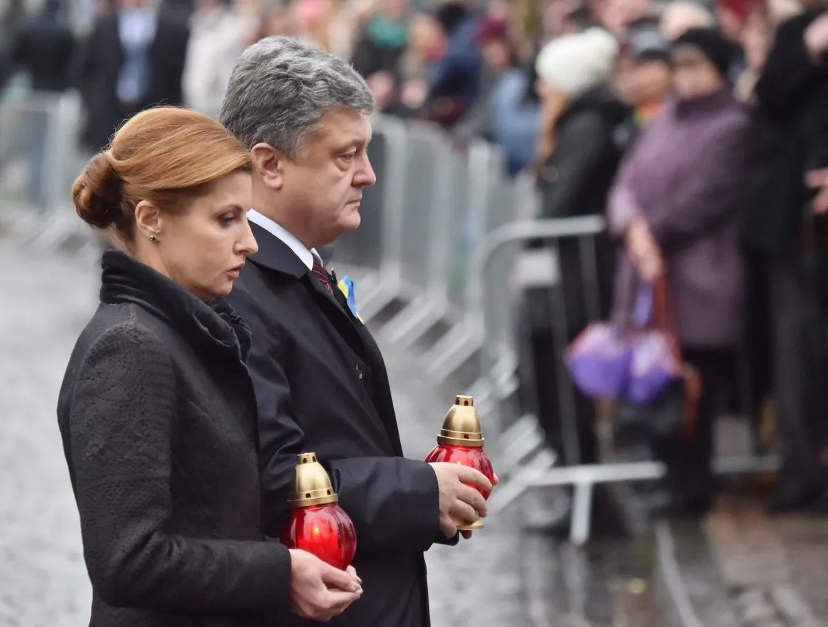 Ukrainian President Petro Poroshenko and his wife Maryna are about to place candles in tribute to Maidan activists who were killed during the Maidan protests in Kyiv on Nov. 21, 2015, as part of a memorial ceremony marking the second anniversary of the beginning of the protests. (Sergei Supinsky/AFP/Getty Images)
