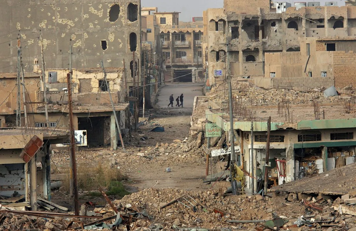 Civilians walk near rubble in the center of Ramadi in Iraq's Anbar Province on Jan. 30, 2007. (John Moore/Getty Images)