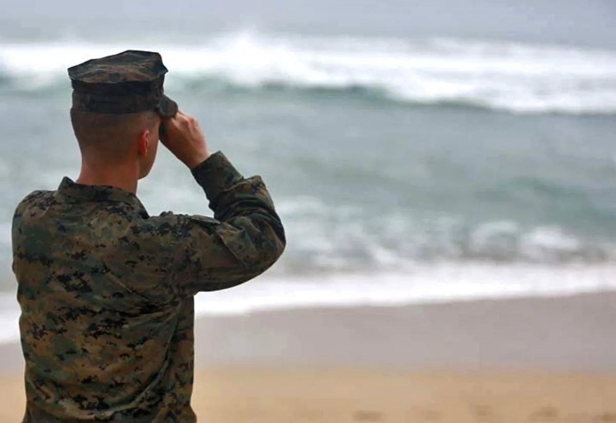 A Marine Officer attached to Marine Heavy Helicopter Squadron 463 uses binoculars to search for debris of a helicopter mishap in Haliewa Beach Park, Hawaii, on Jan. 15, 2016. Rescuers battled winds of up to 23 mph and waves up to 30 feet as they searched for 12 Marines who are missing after two helicopters they were in crashed off the Hawaiian island of Oahu. (Cpl. Ricky S. Gomez/U.S. Marine Corps via AP)