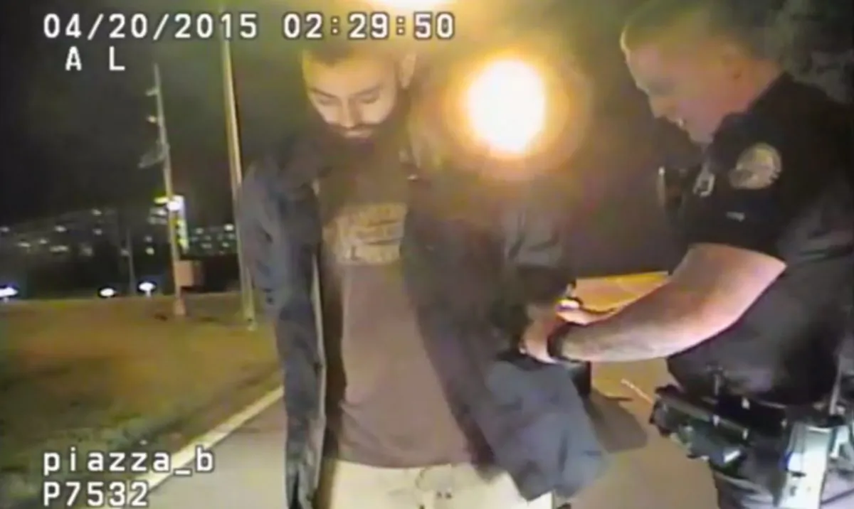 In this April 20, 2015 frame from dashcam video provided by the Chattanooga Police Department, Mohamad Youssef Abdulazeez is detained following roadside sobriety checks in Chattanooga, Tenn. On July 16, Abdulazeez opened fire on a recruiting office and then headed across town and blasted his way through a Navy-Marine reserve center. (Chattanooga Police Department via AP)