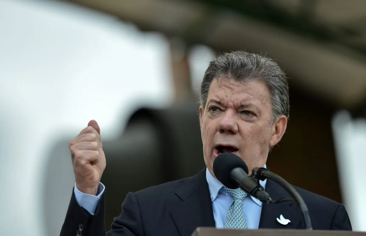 Colombian President Juan Manuel Santos delivers a speech at a military ceremony at the Jose Maria Cordoba Military School in Bogota, on Dec. 19, 2015, during which his ministers of justice and defense signed the government's commitment to the armed forces of not to put at the same level the military personnel who violated the law in the context of the armed conflict with the guerrillas. (Guillermo Legaria/AFP/Getty Images)