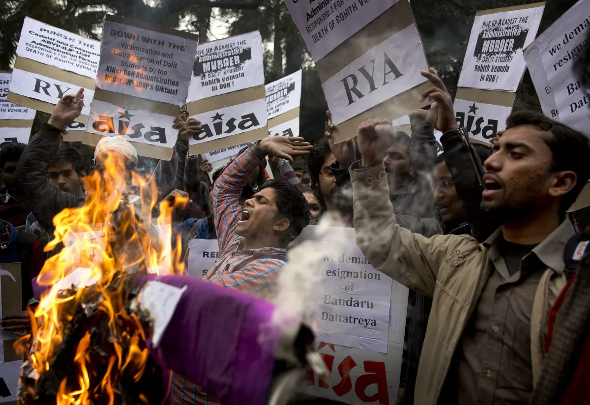 Indian students shout slogans and burn effigies of Hyderabad University's vice chancellor and a federal minister while protesting the death of an Indian student who, along with 4 others, was barred from using some facilities at his university in the southern tech-hub of Hyderabad, in New Delhi, India, (AP Photo/Manish Swarup)