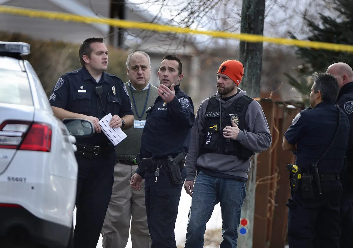 Police talk at the scene of an officer-involved shooting, in Holladay, Utah, Sunday, Jan. 17, 2016. Utah police officer Douglas Barney was killed Sunday, after he was shot by a suspect who was later killed by police. (Scott Sommerdorf/The Salt Lake Tribune via AP) DESERET NEWS OUT; LOCAL TELEVISION OUT; MAGS OUT; MANDATORY CREDIT