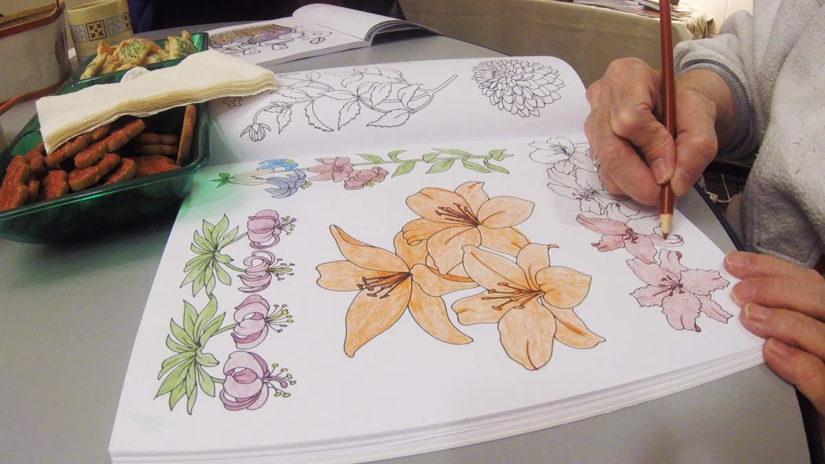 In this Dec. 14, 2015 photo, Carol Hensen colors at the DeForest Public Library in DeForest, Wis. Libraries and other groups nationwide are setting up get togethers for adults to color as the practice of coloring becomes more and more popular. (AP Photo/Carrie Antlfinger)