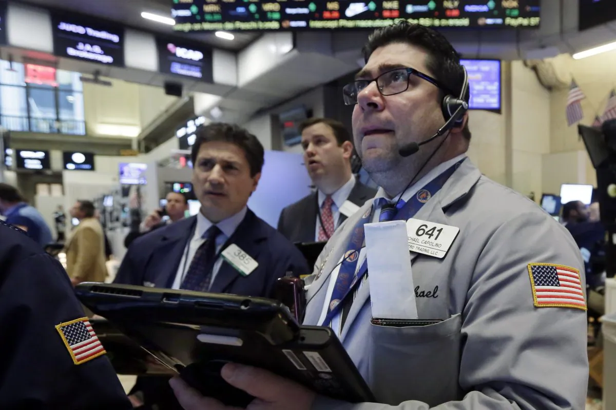 Michael Capolino, right, works with fellow traders on the floor of the New York Stock Exchange, Wednesday, Jan. 20, 2016.  Energy stocks are leading another sell-off on Wall Street as the price of oil continues to plunge. (AP Photo/Richard Drew)