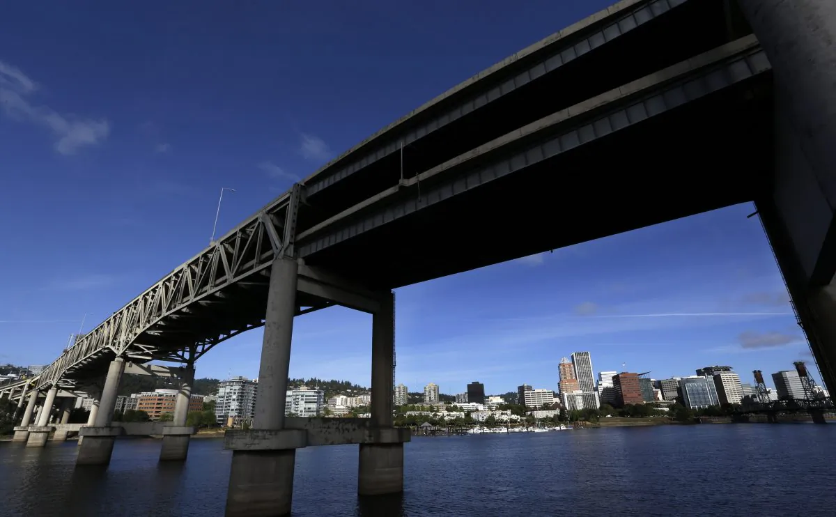 Downtown Portland, Ore., is visible under the Interstate-5 Marquam Bridge on the Willamette River on Aug. 4, 2015. (Don Ryan/AP Photo)
