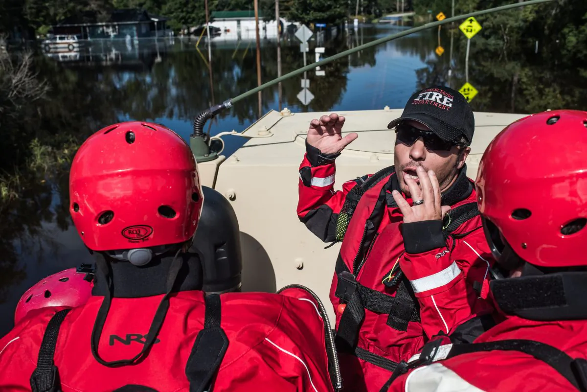 A rescue team takes a ride in an Army National Guard transport vehicle in the Brown's Ferry community October 11, 2015 near Georgetown, South Carolina. (Sean Rayford/Getty Images)
