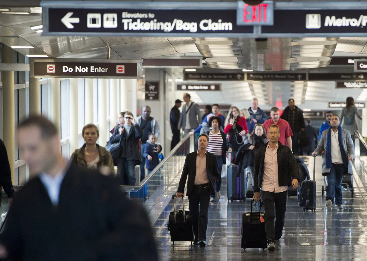 Passengers walk through a terminal after arriving at the Reagan National Airport in Arlington, Va., on Dec. 23, 2015. (Saul Loeb/AFP/Getty Images)