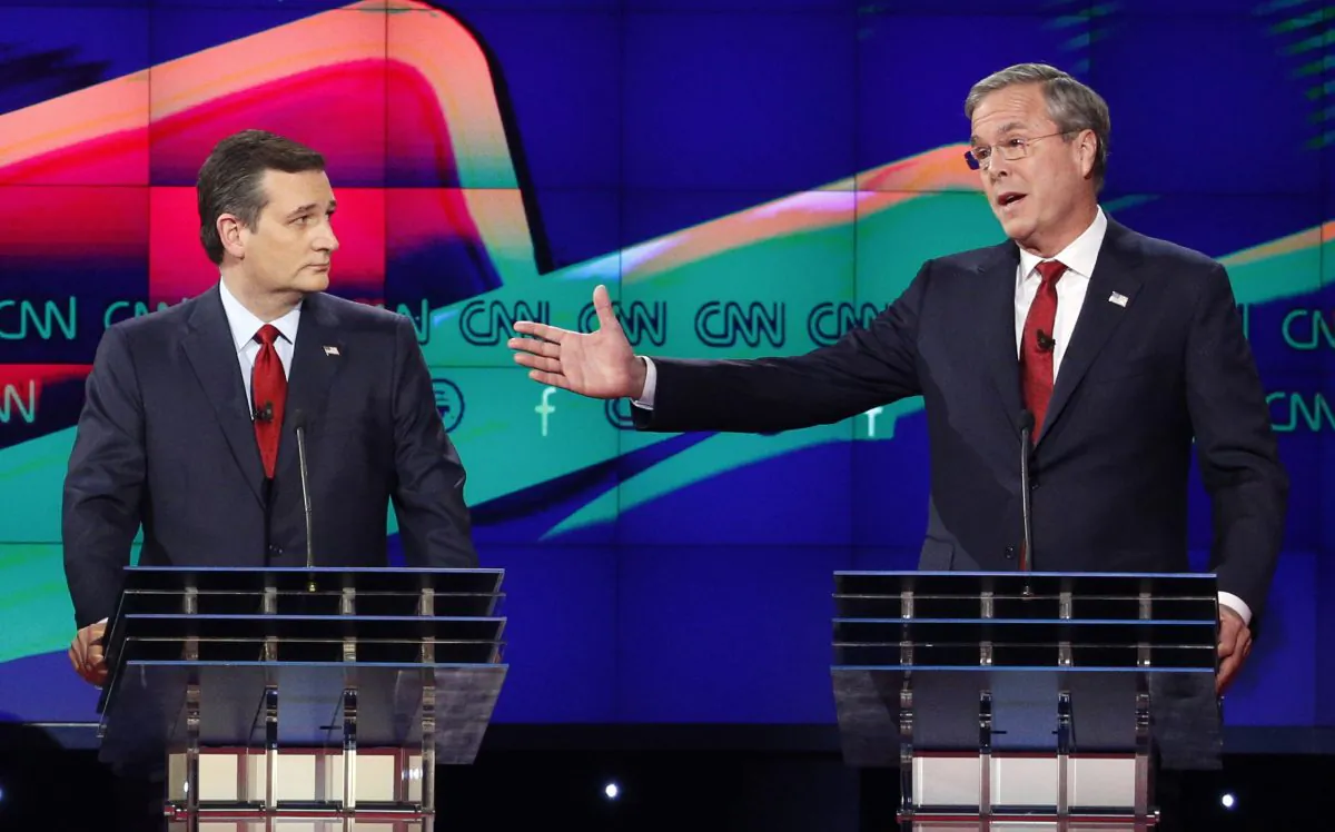 In this Dec. 15, 2015 file photo, former Florida Gov. Jeb Bush, right, makes a point as Sen. Ted Cruz, R-Texas listens on during the Republican presidential debate in Las Vegas. (AP Photo/John Locher)