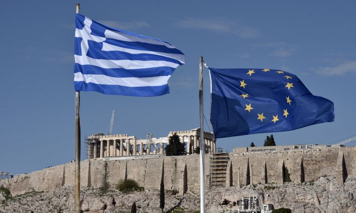 The Greek and EU flags flutter in front of the ancient Acropolis hill in Athens on Jan. 15, 2015. (Louisa Gouliamaki/AFP/Getty Images)