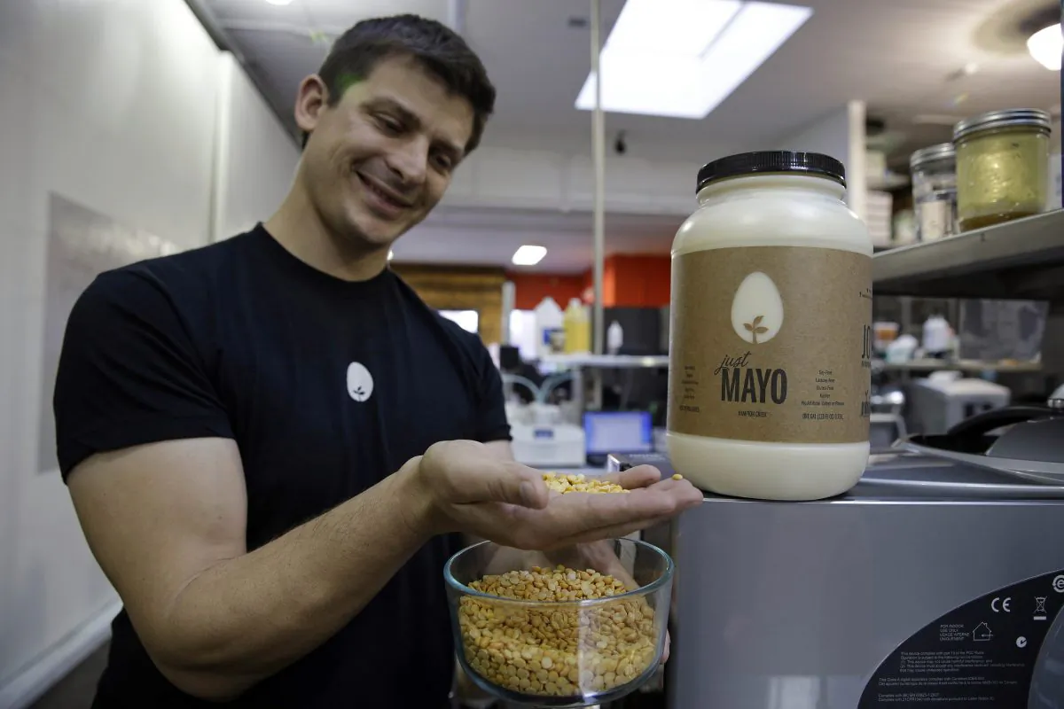 Hampton Creek Foods CEO Josh Tetrick holds the yellow pea used to make Just Mayo, a plant-based mayonnaise, in San Francisco, on Dec. 3, 2013. (AP Photo/Eric Risberg)