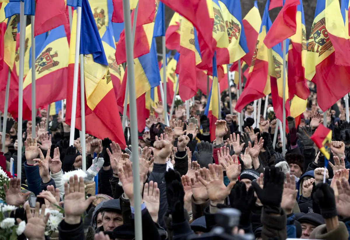 People raise their hands during a large protest in Chisinau, Moldova, on Jan. 24, 2016. More than 15,000 people gathered to protest against the government, demanding early elections in the impoverished East European nation, an action that comes after demonstrators stormed Parliament last week as lawmakers approved a new pro-European government. (AP Photo/Vadim Ghirda)