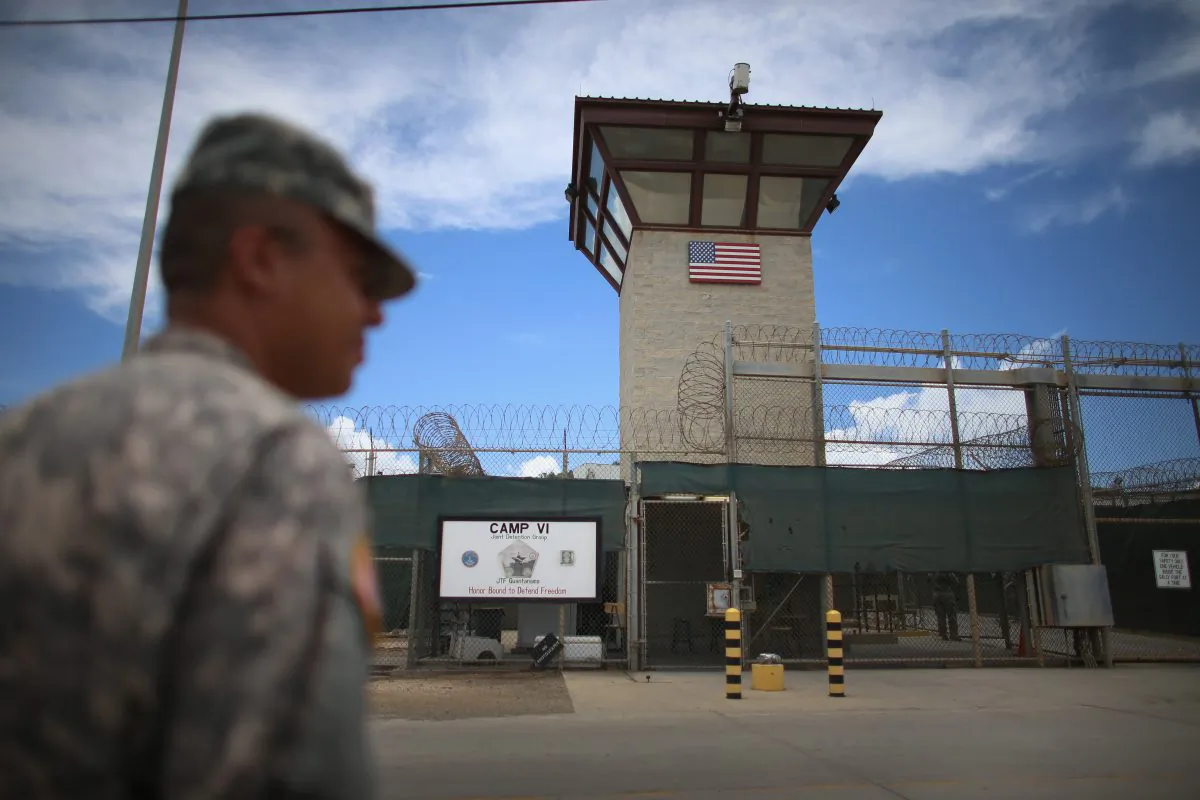 A military officer stands guard near the entrance to Camp VI at the Guantánamo Bay Naval Base in Cuba on March 30, 2013. (Joe Raedle/Getty Images)