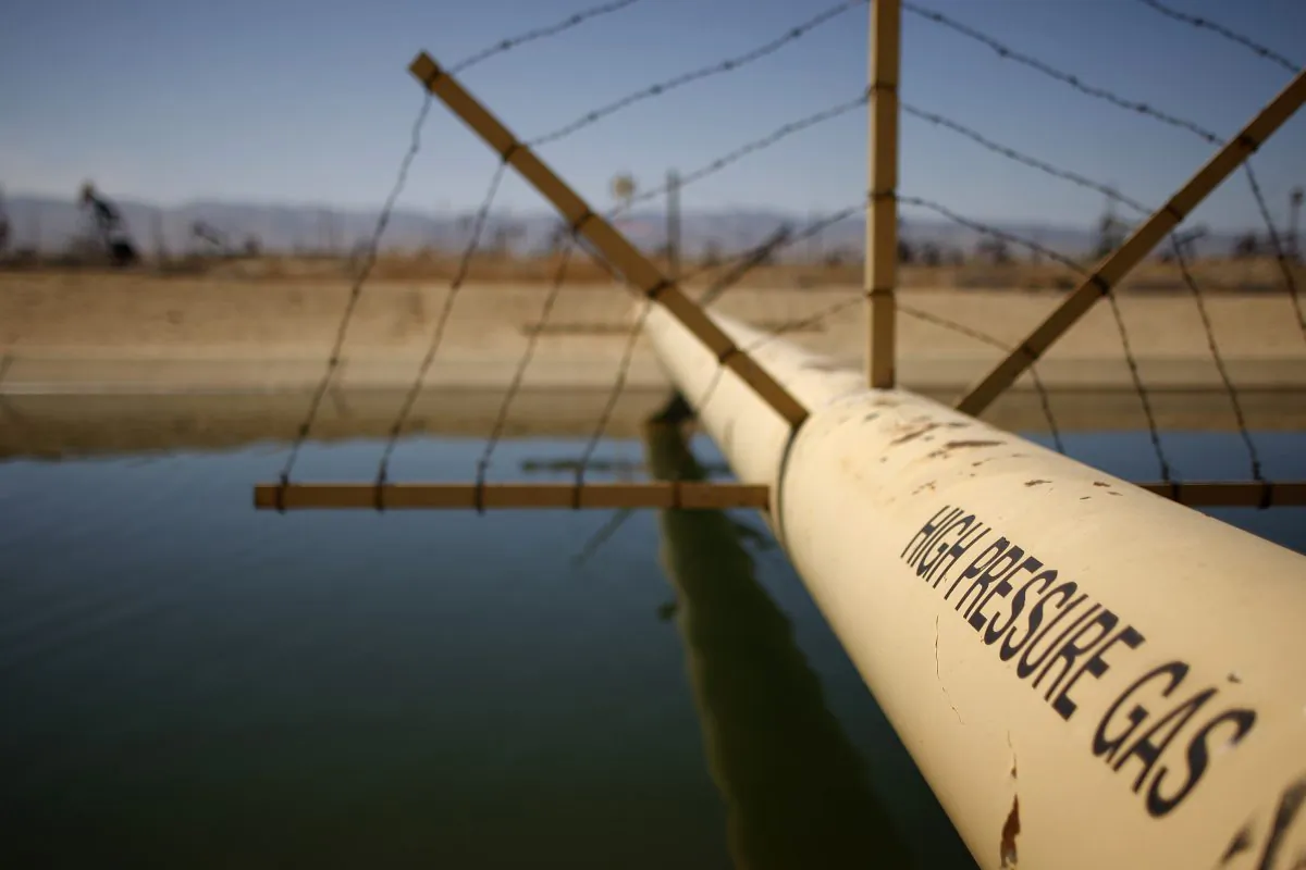A file photo of a high pressure gas line crossing over a canal in an oil field where gas and oil extraction using hydraulic fracturing, or fracking, is being used.  (David McNew/Getty Images).