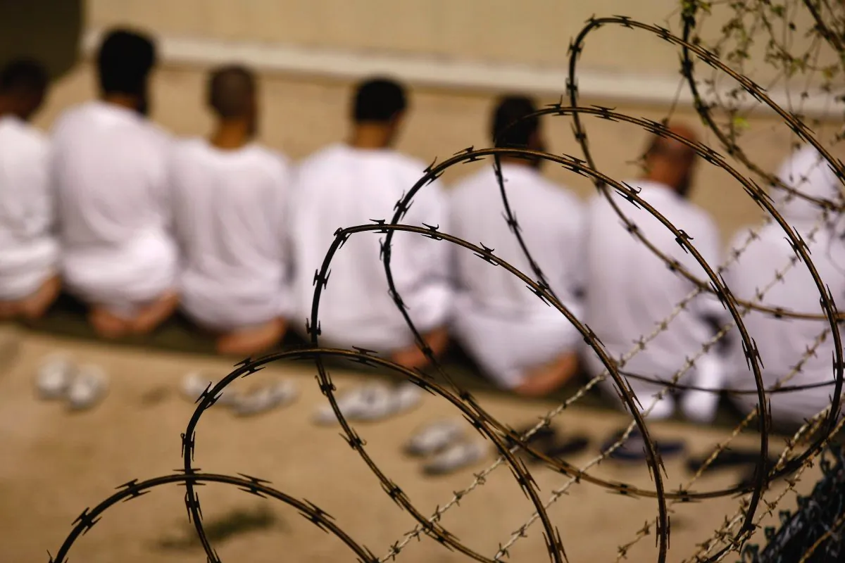 A group of detainees kneels during an early morning Islamic prayer at the Guantánamo Bay Naval Base in Cuba on Oct. 28, 2009. (John Moore/Getty Images)