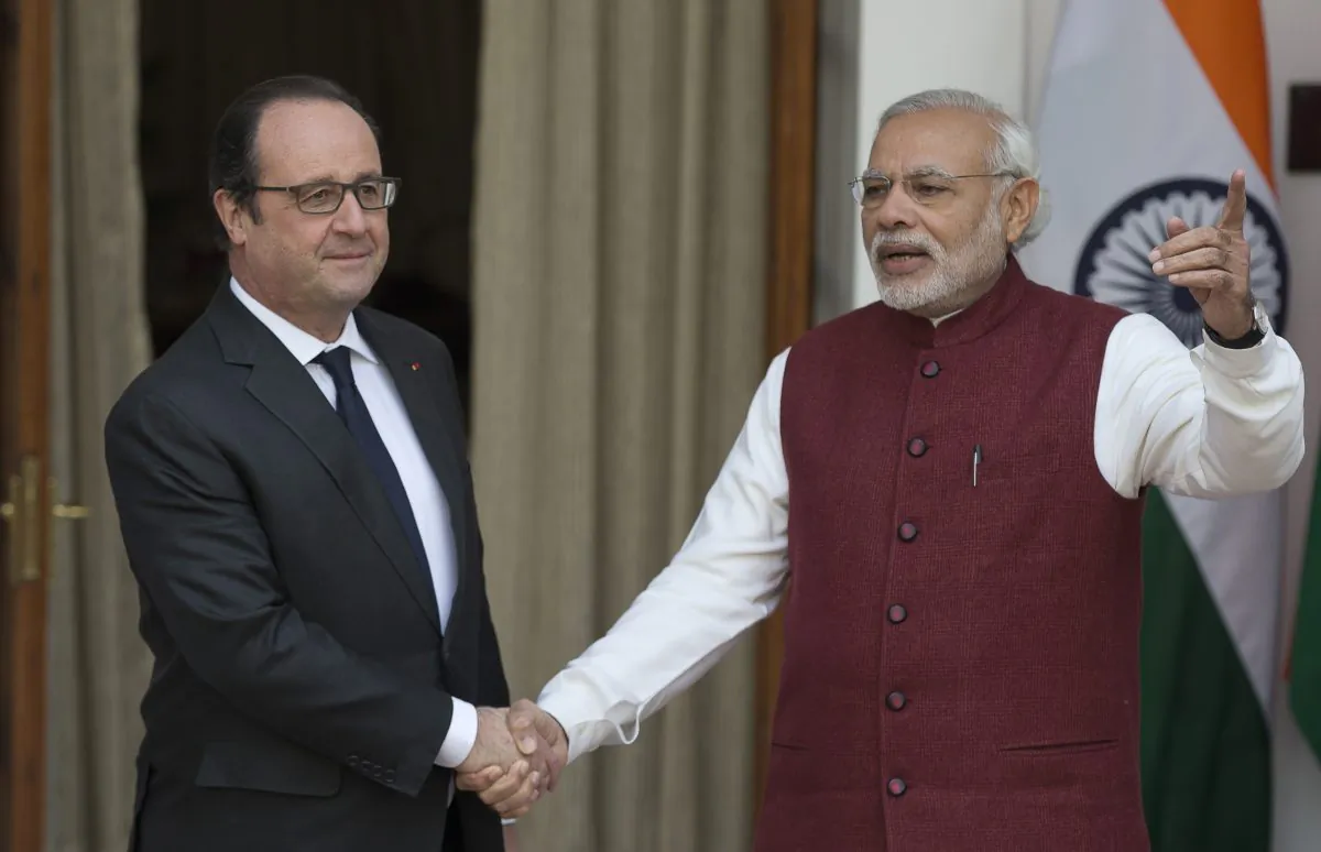 Indian Prime Minister Narendra Modi, right, talks as he greets French President Francois Hollande in New Delhi, India, Monday, Jan. 25, 2016. (AP Photo/Manish Swarup)