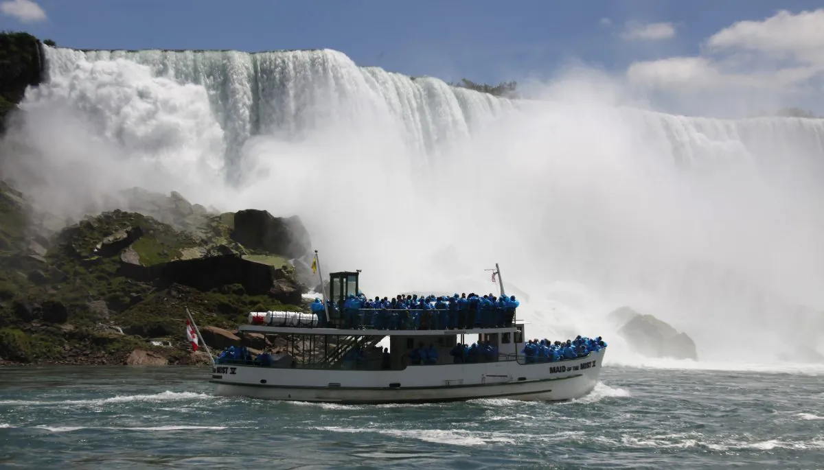 FILE--In this Friday, June 11, 2010 file photo, tourists ride the Maid of the Mist tour boat at the base of the American Falls in Niagara Falls, N.Y. New York officials are considering temporarily turning Niagara Falls into a trickle. State officials are holding a public hearing this week to discuss plans for replacing 115-year-old bridges linking the mainland to islands near the brink of Niagara Falls. To do so, they might reduce the flow on the American side of the falls by building a temporary structure to redirect Niagara River water to the Canadian side. (AP Photo/David Duprey, File)