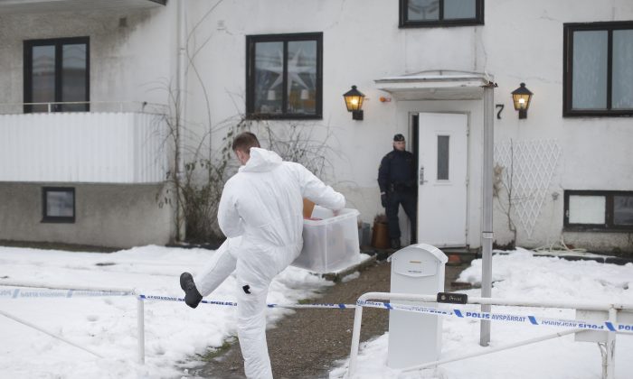 A forensic police officer carries a box of evidence following a search in front of a migrant center in Molndal outside Goteborg, Sweden, Monday, Jan. 25, 2016. A female employee was killed in a knife attack inside the migrant center. (Adam Ihse/ AP Photo) SWEDEN OUT