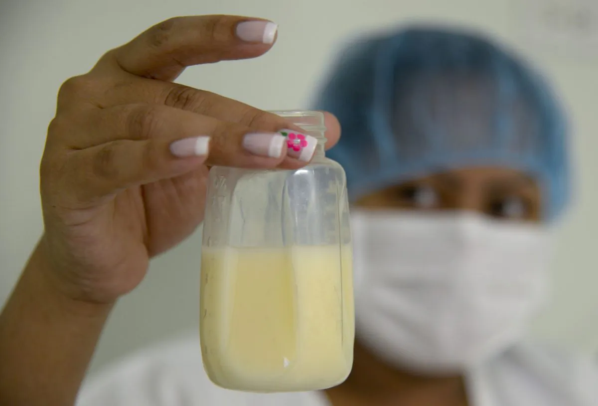 A Colombian mother shows a bottle after collecting breast milk during the first day of donation of human milk at Medellín's General hospital on August 20, 2014 in Medellin, Antioquia department, Colombia. (RAUL ARBOLEDA/AFP/Getty Images)