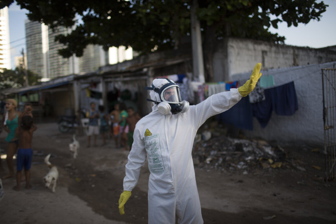 A municipal worker gestures during an operation to combat the Aedes aegypti mosquitoes that transmits the Zika virus in Recife, Pernambuco State, Brazil, on Jan. 26, 2016. (AP Photo/Felipe Dana)