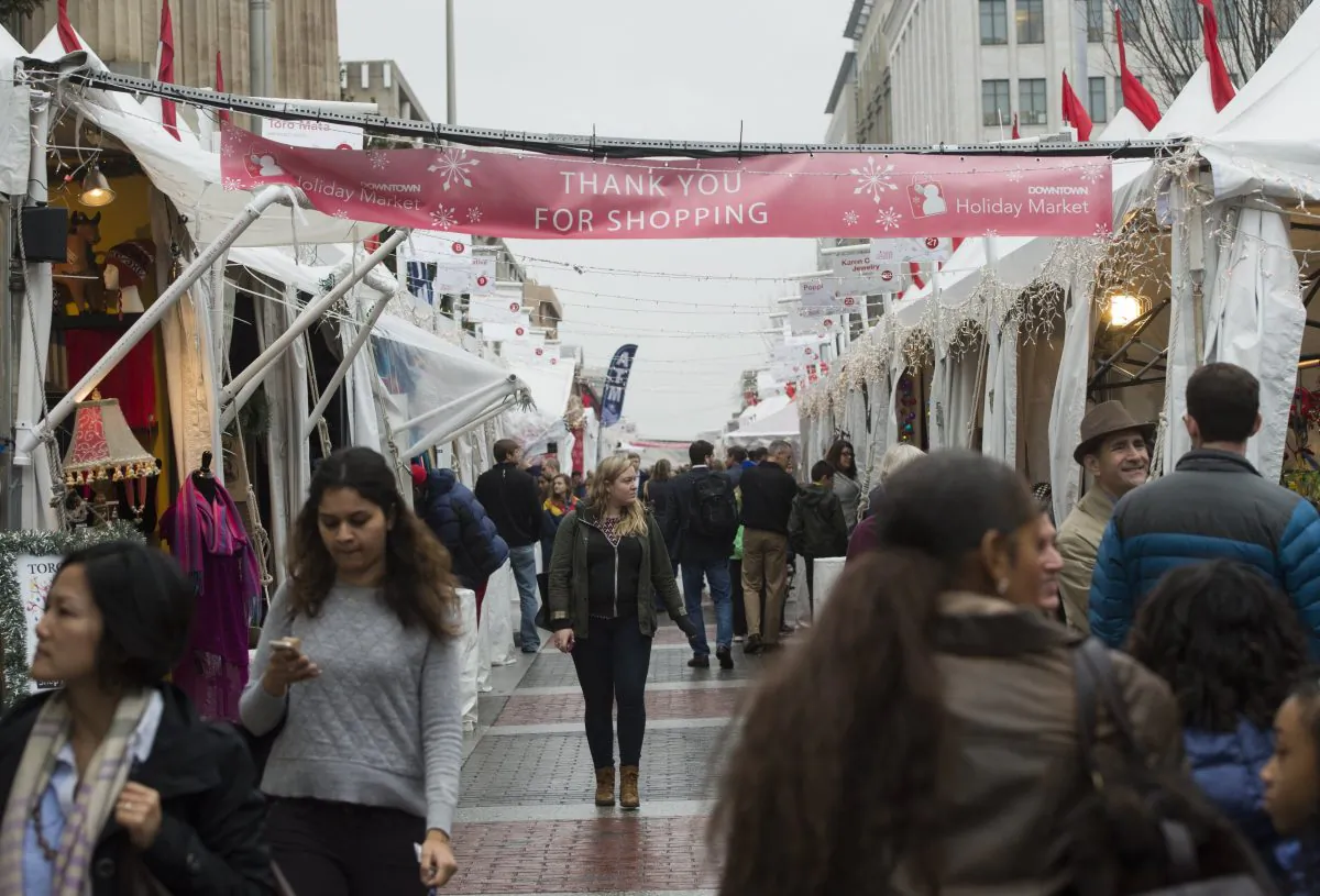 Shoppers walk through the Downtown Holiday Market in Washington, D.C. on Dec. 22, 2015. The U.S. consumer remains in good shape despite a slowdown in economic growth and turmoil in global financial markets. (Saul Loeb/AFP/Getty Images)