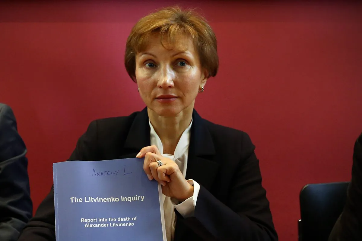 Marina Litvinenko holds a copy of a report at a press conference in her lawyer's office after receiving the results of the inquiry into the death of her husband Alexander Litvinenko, in London, England, on Jan. 21, 2016. Former KGB officer Alexander Litvinenko was poisoned in 2006 with radioactive polonium-210 in the U.K. having fled Russia after criticizing President Vladimir Putin. (Carl Court/Getty Images)