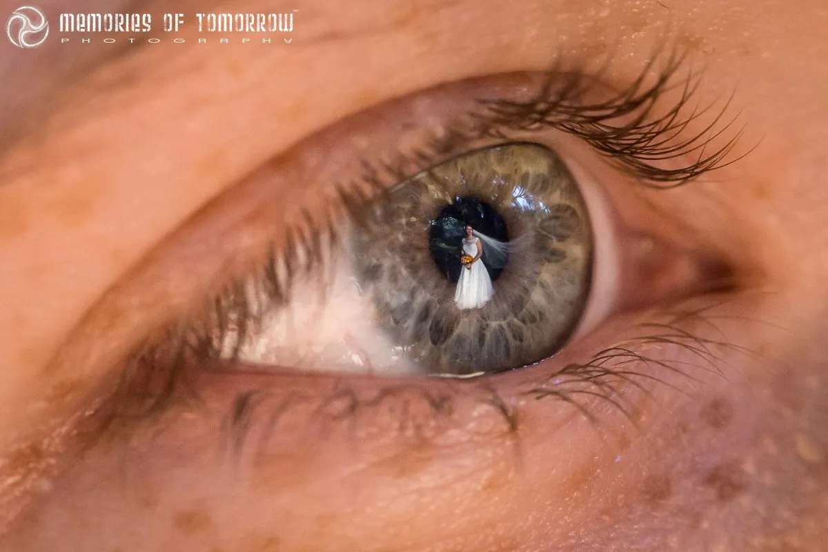 The cliché "Bride's veil blowing in the wind shot"... with that Memories of Tomorrow trademark twist!
(The eye belongs to the groom). ("Eyescapes" by Peter Adams-Shawn)