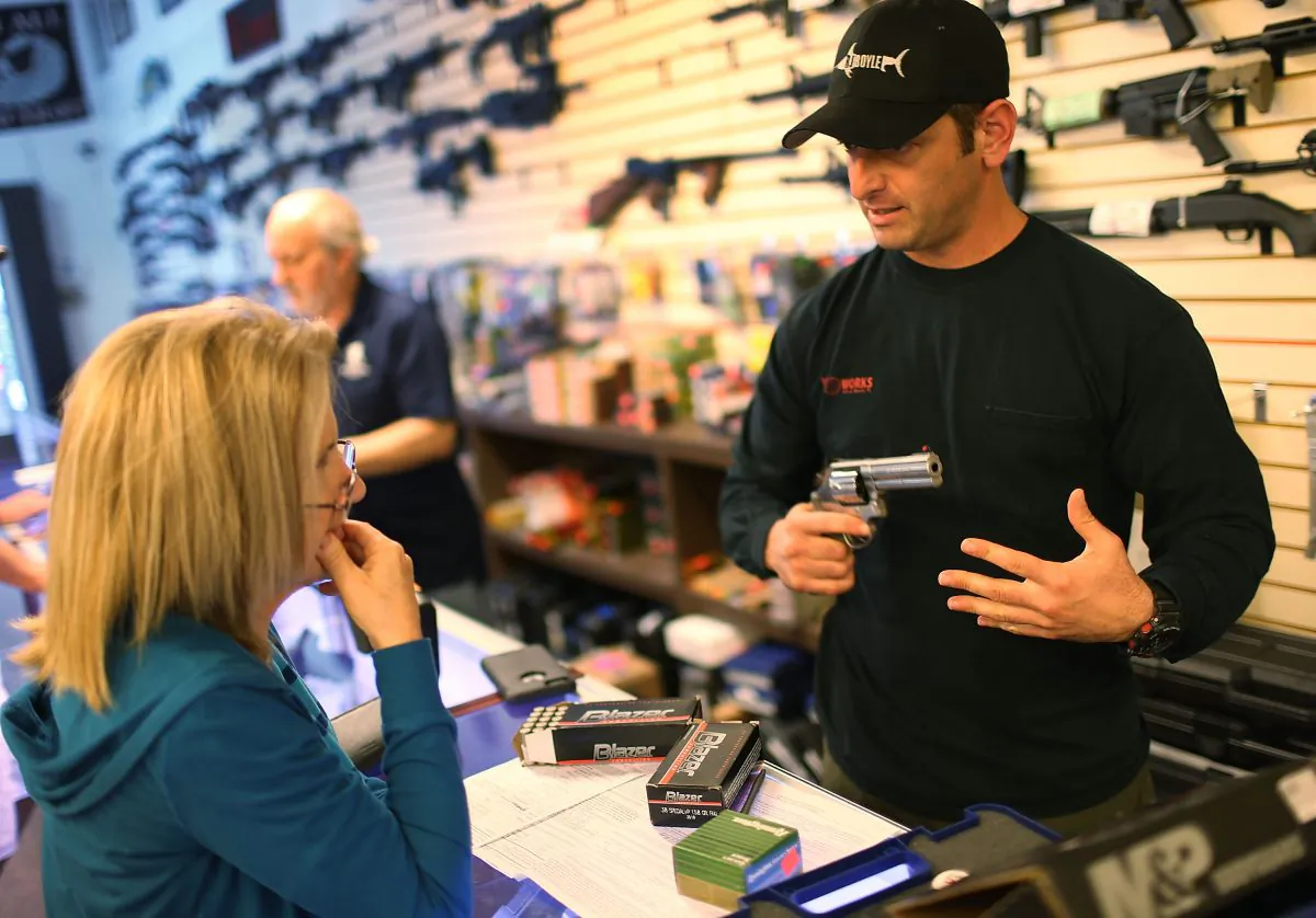 An employee shows weapons to a customer at K&W Gunworks store in Delray Beach, Fla., on Jan. 5, 2016. (Joe Raedle/Getty Images)