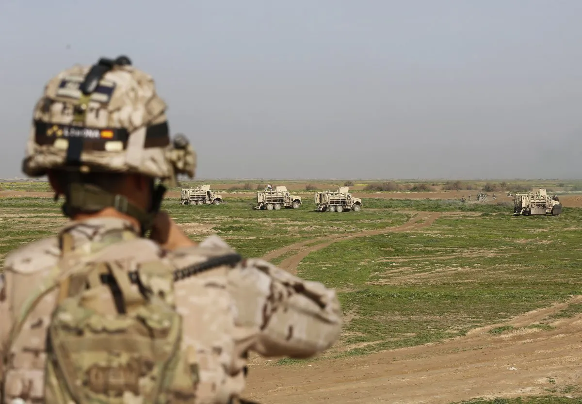 In this Sunday, Jan. 24, 2016 file photo, American and Spanish trainers use live ammunition in training exercises at Basmaya base, 40 kilometers southeast of Baghdad, Iraq. (AP Photo/Karim Kadim)
