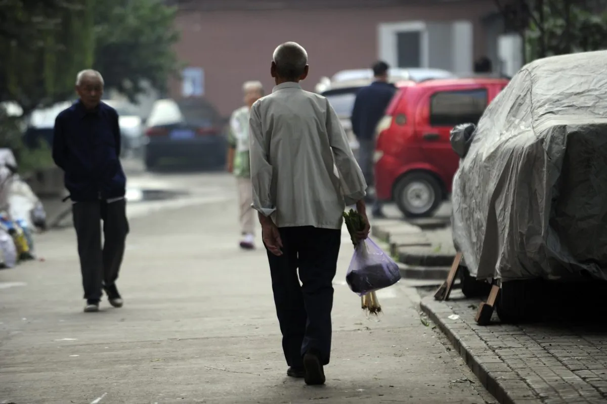 This picture taken on Sept. 7, 2012 shows an elderly man making his way home after buying some vegetables from a market in Beijing. Seniors will be the first to have their pensions cut as China edges closer to a financial cliff, says He Qinglian. (Wang Zhao/AFP/Getty Images)