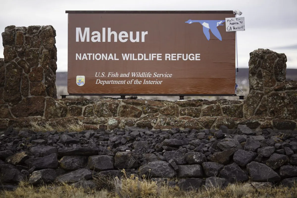 A mop and sign are taped to a sign for the occupied Malheur National Wildlife Refuge near Burns, Ore., on Jan. 29, 2016. (Rob Kerr/AFP/Getty Images)